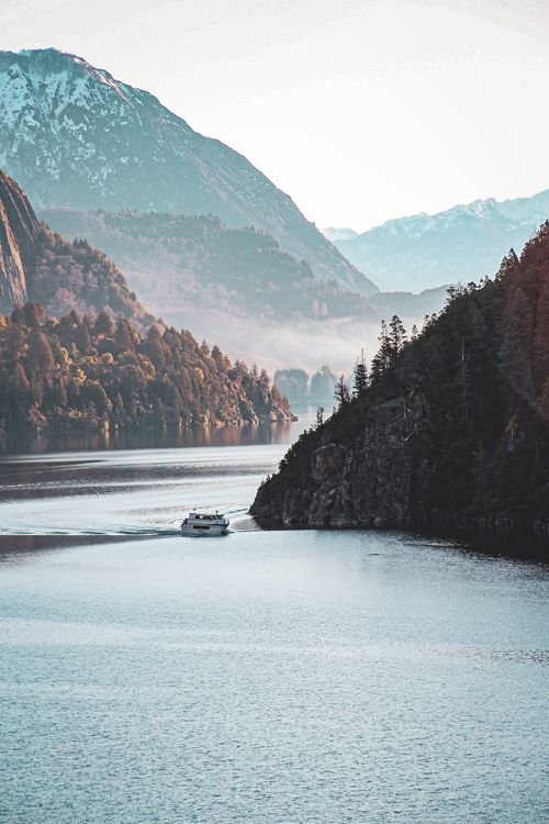 Ferry navegando entre cerros y bosque austral